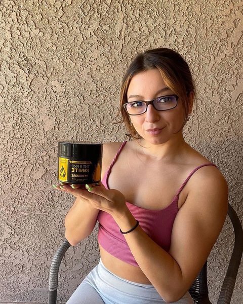 Marisela holding TNT Pro Ignite sweat cream