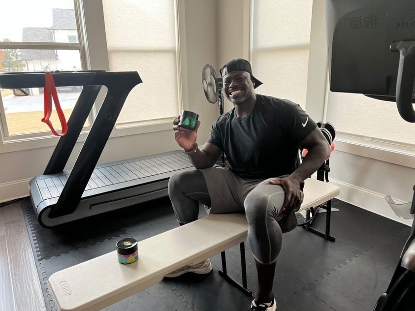 Alex Brown, Former NFL Bears Player, holding TNT Pro Series products